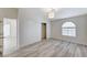 Bedroom featuring sliding closet doors, an arched window and modern light fixture at 2633 S Durango Dr # 201, Las Vegas, NV 89117
