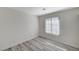 This cozy bedroom is bright with neutral walls, gray-toned flooring, and a window at 2633 S Durango Dr # 201, Las Vegas, NV 89117