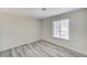 This bedroom offers natural light from the window and modern gray-toned wood-look flooring at 2633 S Durango Dr # 201, Las Vegas, NV 89117