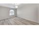 Bedroom with an arched window, gray-toned flooring, and a modern light fixture at 2633 S Durango Dr # 201, Las Vegas, NV 89117