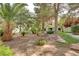 A serene community space with mature trees, lush greenery, stone accents, and a bench at 2633 S Durango Dr # 201, Las Vegas, NV 89117
