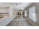 Dining area with modern finishes, sleek lighting fixture and view to the living area and bright windows at 2633 S Durango Dr # 201, Las Vegas, NV 89117