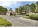 Gated community entrance featuring mature trees and manicured landscaping create a welcoming entry at 2633 S Durango Dr # 201, Las Vegas, NV 89117