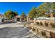 Gated community entrance with mature trees and well-maintained landscaping creating a welcoming entry at 2633 S Durango Dr # 201, Las Vegas, NV 89117
