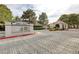 Gated community entrance with mature trees and manicured landscaping provides a sense of privacy at 2633 S Durango Dr # 201, Las Vegas, NV 89117