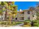 Inviting condo building exterior with mature landscaping and sidewalks, perfect for relaxing outdoors at 2633 S Durango Dr # 201, Las Vegas, NV 89117