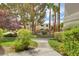 Well-manicured community grounds featuring mature trees, shrubs, and a pathway at 2633 S Durango Dr # 201, Las Vegas, NV 89117
