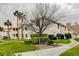The exterior view shows a well-maintained building with palm trees and manicured landscaping at 2633 S Durango Dr # 201, Las Vegas, NV 89117
