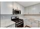Close-up of the kitchen showcasing updated appliances and white countertops at 2633 S Durango Dr # 201, Las Vegas, NV 89117