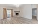 Spacious living area with a fireplace, modern floors, large sliding glass doors, and elegant chandelier at 2633 S Durango Dr # 201, Las Vegas, NV 89117