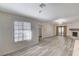 Bright living room featuring light wood floors, large windows, and a cozy fireplace at 2633 S Durango Dr # 201, Las Vegas, NV 89117