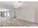 Bright and spacious living room featuring modern flooring, chandelier lighting, and an open floor plan at 2633 S Durango Dr # 201, Las Vegas, NV 89117