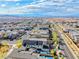 An aerial view of a vibrant neighborhood, showcasing pools, solar panels, and beautiful mountain views at 2637 Via Monet, Henderson, NV 89044