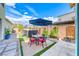 Beautiful backyard with a dining set and a hot tub, ideal for outdoor entertaining and relaxation at 2637 Via Monet, Henderson, NV 89044