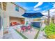 Inviting backyard patio with a dining set, outdoor seating, and a relaxing hot tub under a modern umbrella at 2637 Via Monet, Henderson, NV 89044