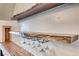 Custom bar area includes wine storage, custom natural wood shelving, and a convenient serving area at 2637 Via Monet, Henderson, NV 89044
