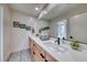 Modern bathroom featuring double sinks, decorative floor tiles, and contemporary hardware at 2637 Via Monet, Henderson, NV 89044
