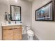 A half-bathroom features modern fixtures and decor, including a wood vanity, contemporary sink, and decorative wall art at 2637 Via Monet, Henderson, NV 89044