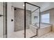 Sleek bathroom featuring a glass-enclosed shower, soaking tub, and modern finishes at 2637 Via Monet, Henderson, NV 89044