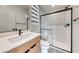 Contemporary bathroom featuring modern fixtures, a glass-enclosed shower and stylish vanity at 2637 Via Monet, Henderson, NV 89044