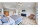Cozy bedroom features vaulted ceiling, wood floors, a dresser, and a comfortable accent chair at 2637 Via Monet, Henderson, NV 89044