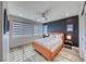 Charming bedroom with neutral walls, wood flooring, and ample natural light from multiple windows at 2637 Via Monet, Henderson, NV 89044