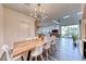 Dining room with direct view into an open kitchen, a modern light fixture, and access to the backyard at 2637 Via Monet, Henderson, NV 89044