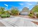 Charming home with a paved driveway leading to a two-car garage, surrounded by landscaped gardens and mature trees at 2637 Via Monet, Henderson, NV 89044