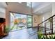 Bright foyer with hardwood floors, modern staircase, and a glimpse into the private outdoor space at 2637 Via Monet, Henderson, NV 89044