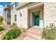 Inviting home entrance with an eye-catching turquoise door, stone accents, and manicured landscaping at 2637 Via Monet, Henderson, NV 89044