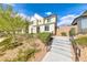 Stylish home with solar panels, xeriscaping, steps, and iron handrails leading up to the front door at 2637 Via Monet, Henderson, NV 89044