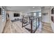 Bright, spacious home gym featuring wood floors, fitness equipment and a modern staircase at 2637 Via Monet, Henderson, NV 89044