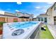 Backyard showcasing a luxurious hot tub surrounded by lush greenery and modern landscaping, perfect for relaxation at 2637 Via Monet, Henderson, NV 89044
