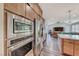 Open kitchen design with stainless steel appliances and ample cabinet storage at 2637 Via Monet, Henderson, NV 89044