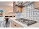 Contemporary kitchen featuring a stainless steel cooktop, stylish tile backsplash, and custom wood cabinetry at 2637 Via Monet, Henderson, NV 89044
