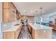 Open kitchen with long center island, stainless appliances, and direct access to living room at 2637 Via Monet, Henderson, NV 89044