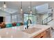Modern kitchen island features a sleek sink, countertop, and pendant lighting creating a welcoming space at 2637 Via Monet, Henderson, NV 89044