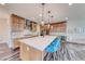 Modern kitchen featuring a large kitchen island with barstool seating and stainless steel appliances at 2637 Via Monet, Henderson, NV 89044