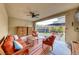 Inviting covered patio with comfortable seating, ceiling fan, and views of the backyard at 2637 Via Monet, Henderson, NV 89044