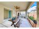 Relaxing covered patio with a ceiling fan, dining table, and views of the serene courtyard at 2637 Via Monet, Henderson, NV 89044
