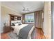 Bright bedroom with a built-in headboard bookshelf and a window seat overlooking the landscaping at 2702 Grand Forks Rd, Henderson, NV 89052
