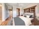 A well-lit bedroom featuring a built-in headboard bookshelf and hardwood floors at 2702 Grand Forks Rd, Henderson, NV 89052
