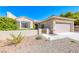 Charming one-story house with a neutral exterior, complemented by a two-car garage, inviting curb appeal, and xeriscaped front yard at 2702 Grand Forks Rd, Henderson, NV 89052