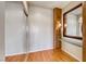 Hallway view with hardwood floors, recessed lighting, mirror, and a decorative wall sconce at 2702 Grand Forks Rd, Henderson, NV 89052