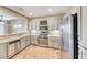 Modern kitchen featuring stainless steel appliances, light wood cabinets, and a convenient layout for cooking at 2702 Grand Forks Rd, Henderson, NV 89052