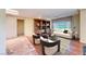 Open-concept living area with hardwood floors, built-in shelving, a comfortable sofa, and great natural light at 2702 Grand Forks Rd, Henderson, NV 89052