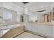 Modern bathroom with large mirror, bathtub, double sinks, and round window at 2877 Paradise Rd # 1804, Las Vegas, NV 89109