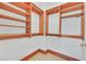 Spacious walk-in closet with custom shelving and wooden trim at 2877 Paradise Rd # 1804, Las Vegas, NV 89109