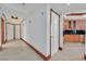 Bright hallway with travertine flooring, wood trim, and access to the kitchen at 2877 Paradise Rd # 1804, Las Vegas, NV 89109