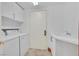 Well-lit laundry room with washer, dryer, sink, and cabinet storage at 2877 Paradise Rd # 1804, Las Vegas, NV 89109